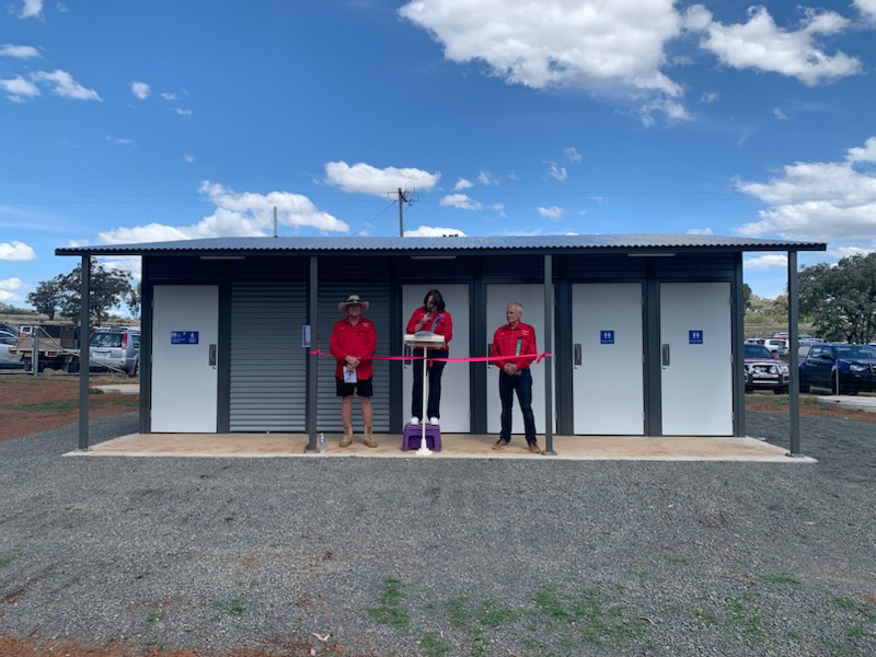 Two men and a woman standing in front of the new amenity block at Tooraweenah Showground